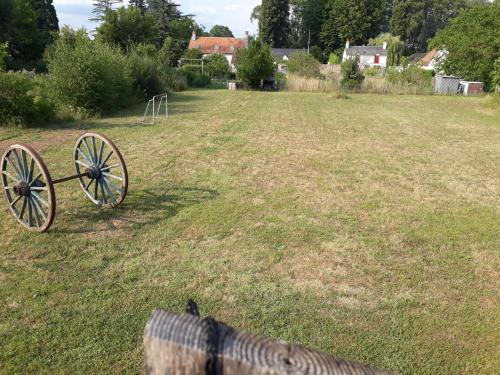 a bench in a field with a cannon in the grass at pastelle in Contres