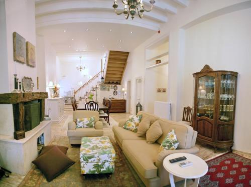 a living room with a couch and a table at Archontiko Petras 1821 in Petra
