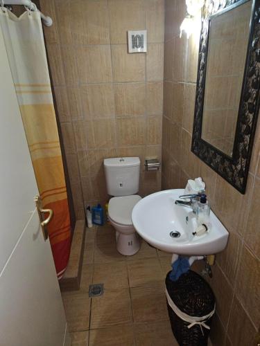 a bathroom with a toilet and a sink at Villa Maria in Porto Heli