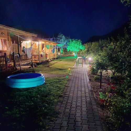 a cobblestone path in a yard at night at Fidelya Bungalow Evleri in Adrasan