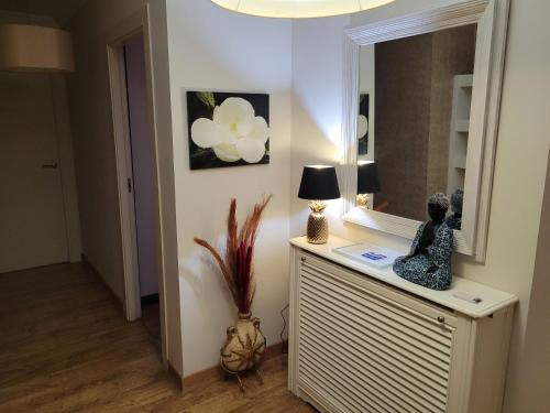 a room with a mirror and a lamp on a dresser at Privada Confort Granada in Granada