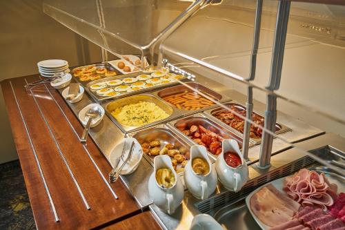 a buffet with a lot of different types of food at Wellness Hotel Queens in Mariánské Lázně