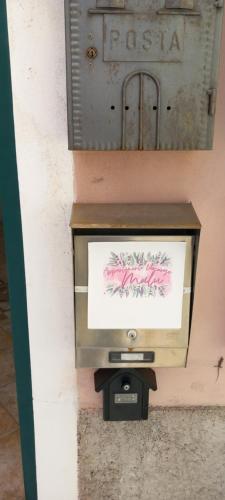 a tv in a wall with a sign on it at Appartamento Vacanze Malù in Moneglia