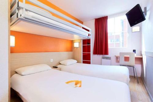 a hotel room with two beds and a tv at Premiere Classe Tours Sud - Joue Les Tours in Joué-lès-Tours
