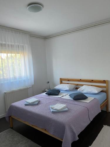 a bedroom with two beds with towels and a window at Apartment T&M Zagreb Airport in Velika Gorica