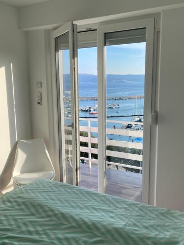 a bedroom with a bed and a view of the ocean at Villa Luca in Novi Vinodolski