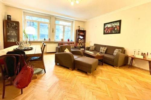 a living room with a couch and a table at Economy apartment 2 min from the main station in Bratislava