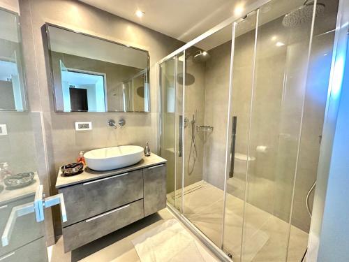 a bathroom with a sink and a glass shower at Aristomenis Studios in Vlachata