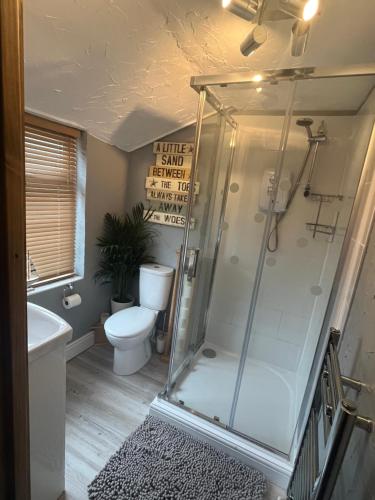 uma casa de banho com uma cabina de duche e um WC. em The Annexe em Winterbourne