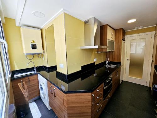 a kitchen with a sink and a counter top at Apartamento NEPTUNO - Primera Línea de Playa by SunCastle apartamentos in El Campello