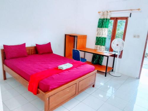 A bed or beds in a room at Flores One Love Homestay