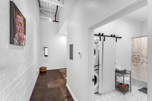 a white hallway with a washing machine in a room at Deep Ellum Art Novea in Dallas