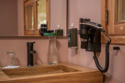 a telephone is hanging on a wall above a sink at Las Qolqas EcoResort Ollantaytambo in Ollantaytambo