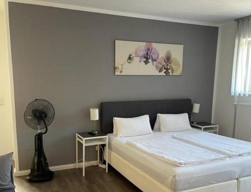 ein Schlafzimmer mit einem großen Bett und einem Ventilator in der Unterkunft HD City Apartments in Heidelberg