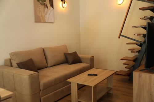 a living room with a couch and a coffee table at GOLDEN VIEW Sokobanja in Soko Banja