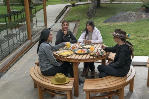 a group of women sitting around a table at Las Qolqas EcoResort Ollantaytambo in Ollantaytambo