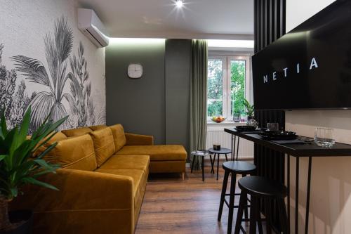 a living room with a couch and a bar at FREEDOM APART Akacjowa 17m1B in Zielona Góra
