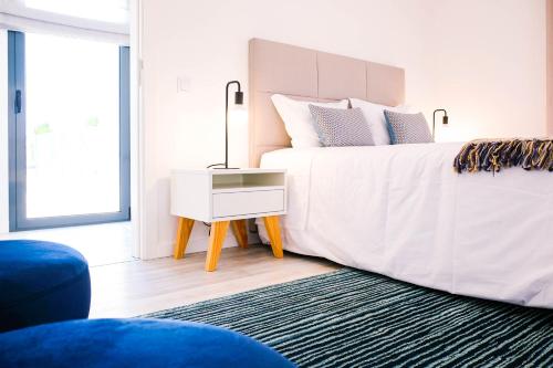 a bedroom with a large bed with a night stand at Villa Serra Mar in São Martinho do Porto