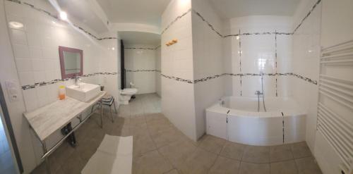 een badkamer met een bad, een wastafel en een toilet bij la halte des trois rivieres in Plichancourt