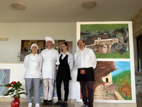 a group of people standing in front of a painting at Terrae Eremis: Ristorante, Bar, B&B in Roccamorice