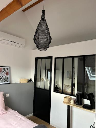 a bedroom with a bed and a pendant light at La Paulerie in Wacquinghen