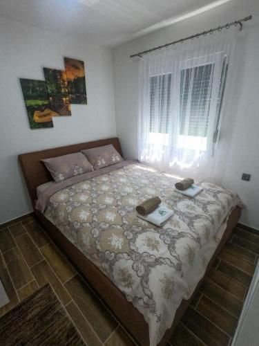 a bedroom with a bed with two phones on it at Vikendica na Drini - Drinska priča in Loznica