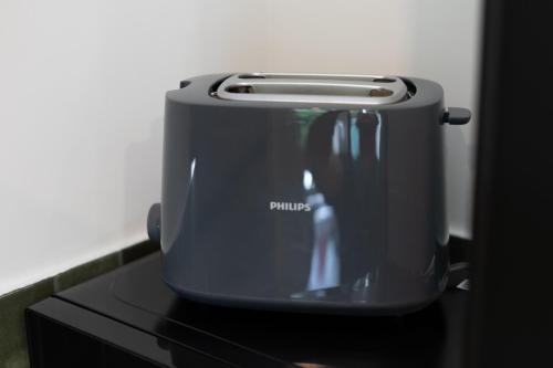 a toaster sitting on top of a black counter at FLATMORE Apartament Akacjowa 17m1B in Zielona Góra