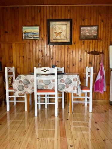 a dining room with a table and four chairs at Odmaralište Petnjica in Šavnik