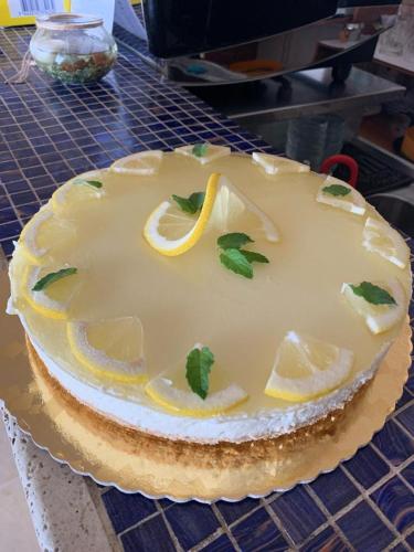 a cake with lemon slices on top of a table at Terrae Eremis: Ristorante, Bar, B&B in Roccamorice