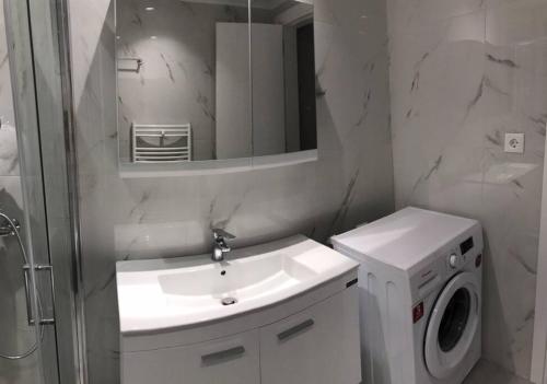 a bathroom with a sink and a washing machine at Luxury spacious apartment in the heart of the city in Rhodes Town