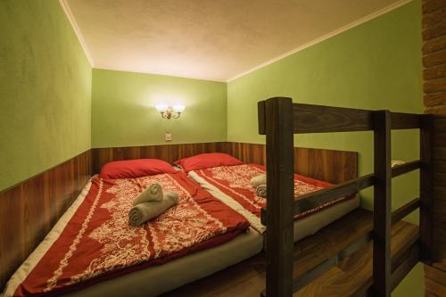 Un dormitorio con una litera con almohadas rojas. en Apartmán u Bretschneidera, en Banská Štiavnica