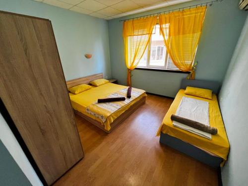 a room with two beds and a window at Romance in Pomorie