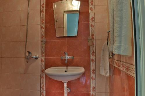 a bathroom with a sink and a mirror at Romance in Pomorie