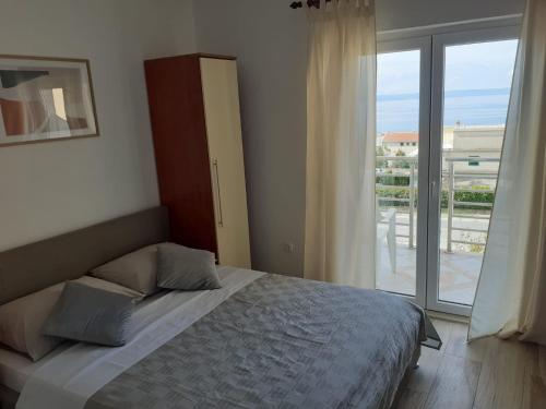 Una cama o camas en una habitación de Apartmani Rudan