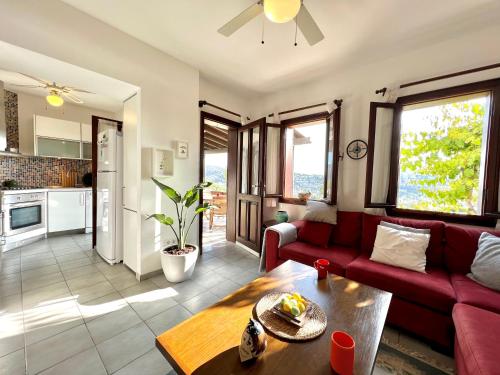 a living room with a red couch and a table at Seaview Grand - MAGIC Gundogan in Bodrum City