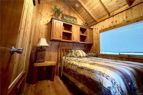 a bedroom with a bed in a wooden cabin at Oak Knoll Village in Palomar Mountain