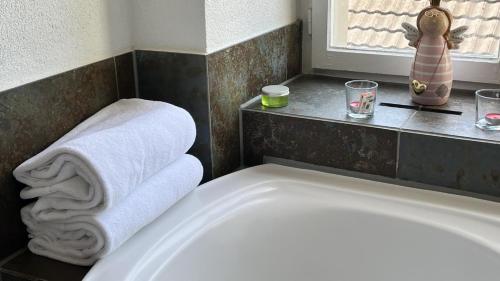 a bath tub with towels and a window in a bathroom at Hotel Krone Sihlbrugg in Sihlbrugg Dorf