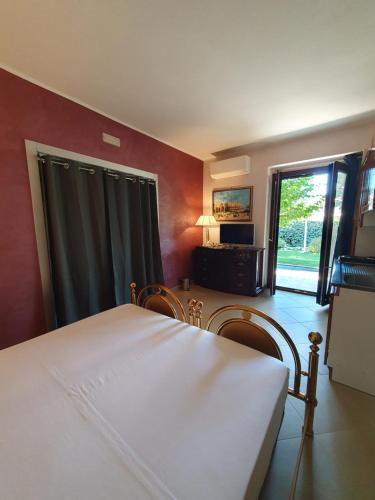 a bedroom with a bed and a large window at EDEN RELAX in Termoli