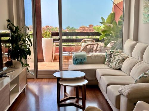 a living room with a couch and a table at Playa Granada Golf Apartamentos in Motril