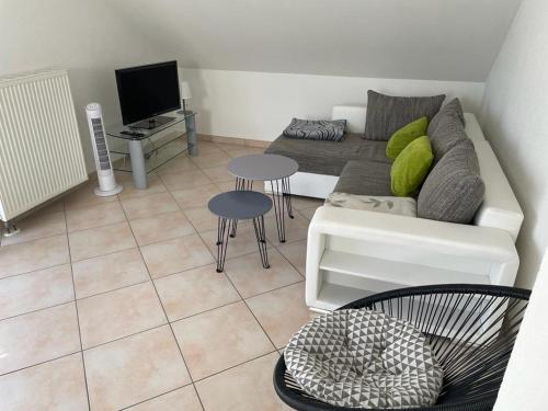 a living room with a couch and a tv at Ferienwohnung Blumenfeld in Gengenbach