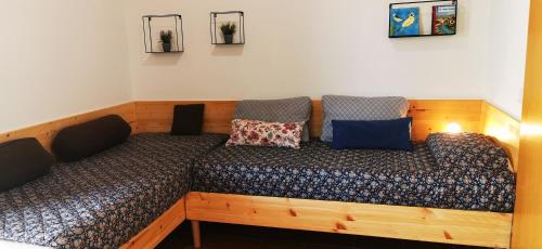 a bed with two pillows on it in a room at Apartments Ritoša in Izola