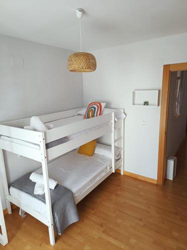 a white bunk bed in a room with a lamp at PISO VISTA BELLA in Monachil