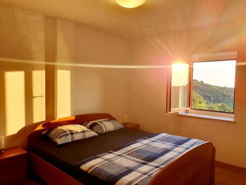 a bedroom with a bed and a window at ForRest Apartment in Portorož