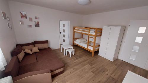 a living room with a couch and a bunk bed at Apartmán Velehrad in Velehrad