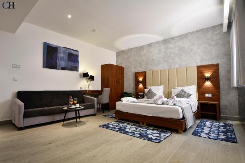 a hotel room with a bed and a couch at Hotel Chaker in Batna