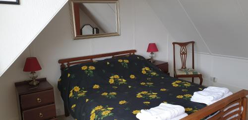 a bedroom with a bed with yellow flowers on it at Tigh na Camus in Glenelg