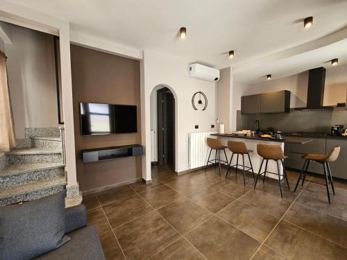 a kitchen with a counter and chairs in a room at Al Dolce Vita in Stresa