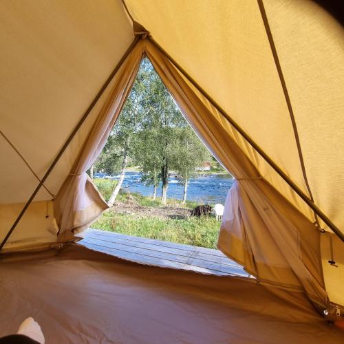 a view from inside a tent with a window at Flatheim Glamping in Viksdalen