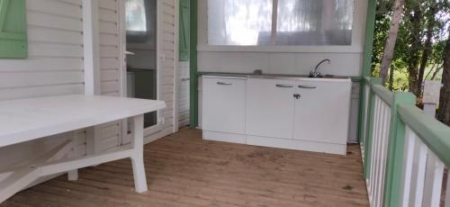 a kitchen with a white counter and a sink at Mobil home 6-8 places en Camping 4etoiles Saint Cyprien in Saint-Cyprien