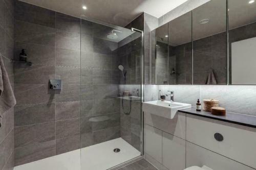 a bathroom with a glass shower with a sink and a shower at The Union in London